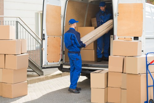 Man with a van loading furniture in Barnes residential street