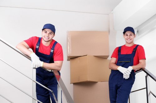 Careful wrapping of fragile household items for a move in Barnes
