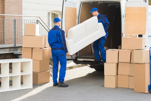 Loading furniture into a removals van on a Barnes residential street