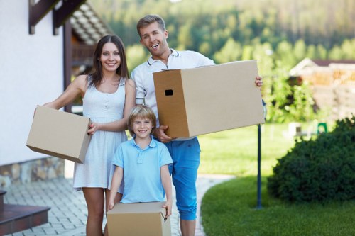 Moving boxes and furniture being loaded for a Barnes man and van service