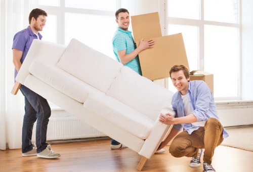 Local movers loading desks and chairs for an office move in Barnes